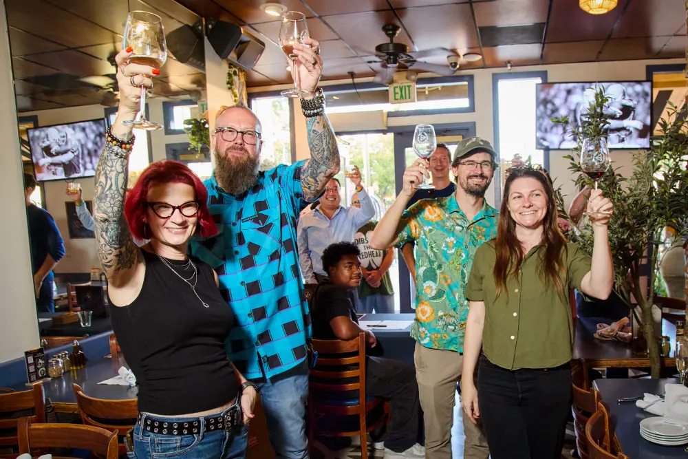 Glasses raised together at Demitri’s Taverna on DPC kickoff night