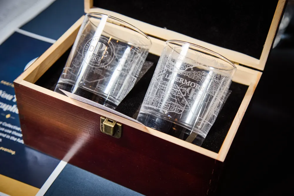 Two etched rocks glasses inside their latched wooden keepsake box